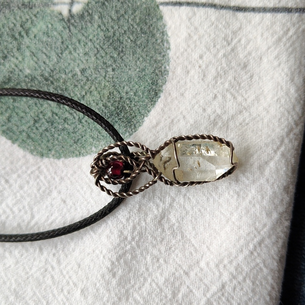 Small garnet and quartz crystal wire wrapped goddess pendant.